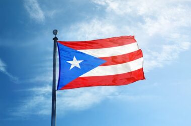 Puerto Rico flag flying in the blue sky.